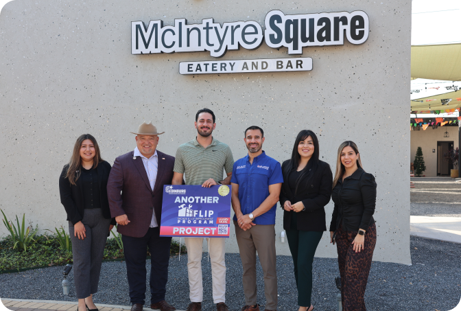 Edinburg EDC staff and business owners celebrating a completed FLIP Program project at McIntyre Square