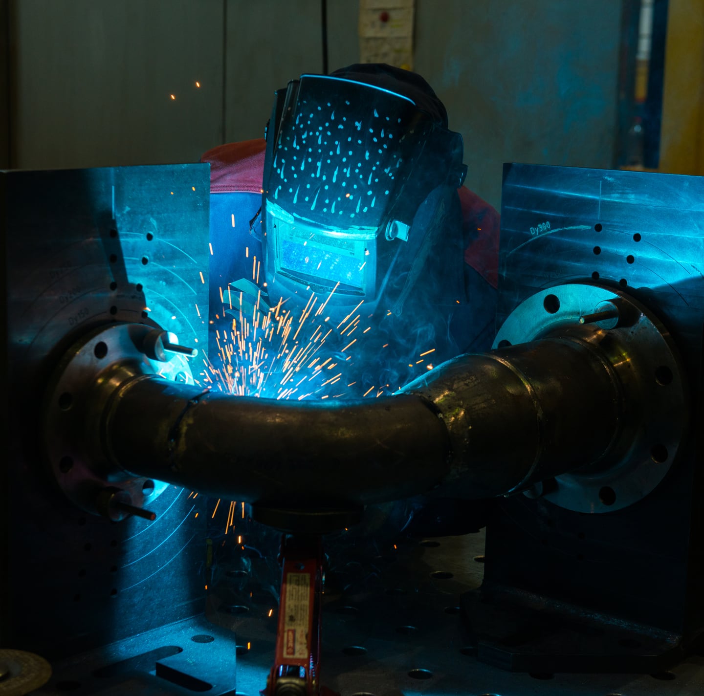Welding sparks on a steel pipe assembly
