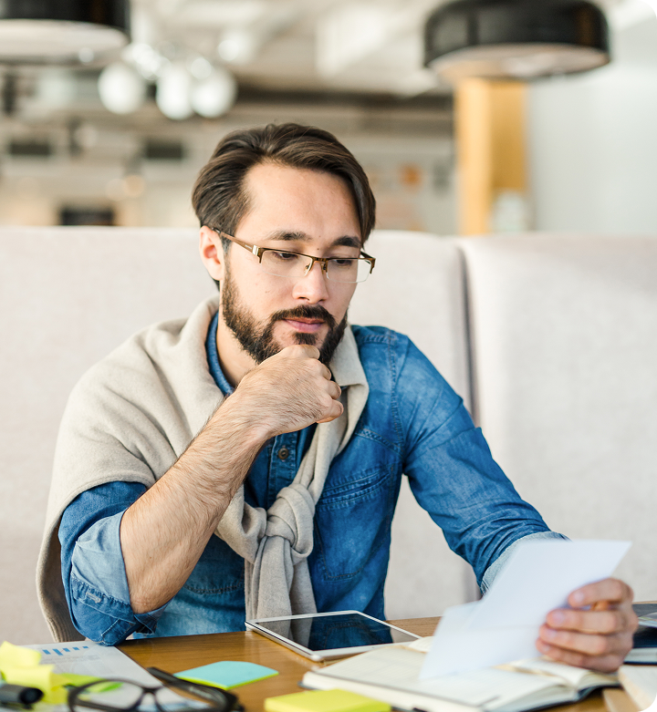 A small business owner reviewing paperwork at a desk